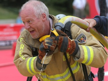 Bill Kaufmann of Postmedia struggles to aim his firehose during the Firefit Challenge at Spruce Meadows Friday June 10, 2016 on day three of The National.