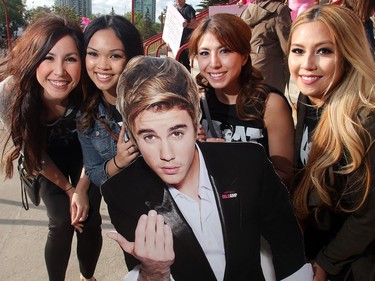 Rhea Campbell, Joy Almerol, Shaual Cay and Jen Villavroza pose along Mr. Justin Bieber's likeness on their way into the Saddledome for his concert Monday Night June 13, 2016.