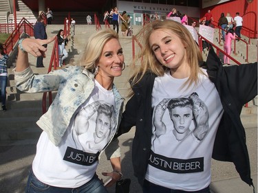 Mom and daughter Justin Beiber fans Brandy Phillips, left, and her daughter Tiana Belcastro wear their Justin colours on the way into the Saddledome for his concert Monday Night June 13, 2016.