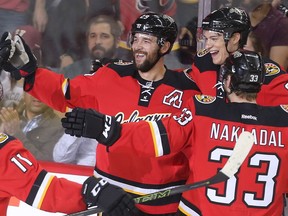 Derek Engelland of the Calgary Flames celebrates with teammates after scoring on the Vancouver Canucks, a 7-3 win, during the final home game of the year at the Saddledome April 7, 2016.