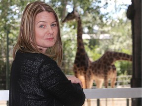 Calgary Zoo curator Colleen Baird with giraffes in the background in the African Savannah building Wednesday June 15, 2016. The building, and the giraffes, were heavily affected by the flooding Bow River three years ago.