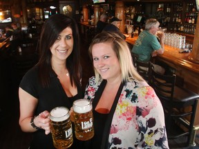 Des Nagy, left, and Samantha Grainger of Dixon's Public House toast the new rules allowing all day and all night Happy Hours announced by the NDP government Friday June 3, 2016.
