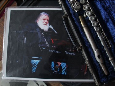 A photograph of Kelly Jan from his days fronting Canadian rockband Crowbar beside a battered flute in his cluttered home in Penbrooke Meadows.