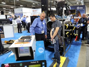 Delegates explore the booths at the Global Petroleum Show in the BMO centre at Stampede Park.