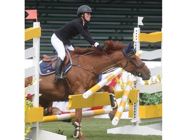 Vanessa Mannix and her horse Carolien VH Scheefkasteel crash through a fence on the Spruce Meadows course during the Back on Track Cup Wednesday June 8, 2016 on the opening day of The National.