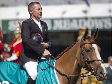 Canadian Eric Lamaze sits astride Melody Des Hayettes Z to listen to the national anthem after wiining the ATCO Challenge on day two of the Spruce Meadows National Thursday June 9, 2016.