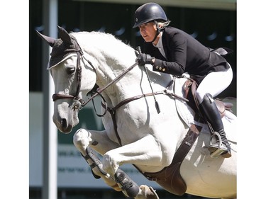 Brenda Riddel of Calgary rides Wilson in the the jump off portion of the ATCO Challenge on day two of the Spruce Meadows National Thursday June 9, 2016.