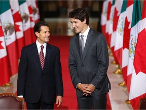 Mexican President Enrique Pena Nieto(L) and Canadian Prime Minister Justin Trudeau arrive to speak with the media following bilateral meetings ahead of the "Three Amigos Summit" at Parliament Hill in Ottawa, June 28, 2016.