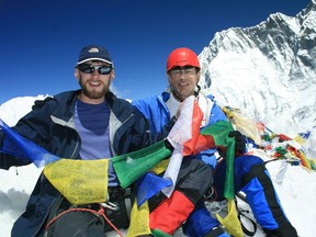 Charles MacAdams, right, at the summit of Island Peak in Nepal with his son, Jeff, in 2010. MacAdams died at Everest base camp on May 11.