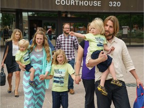 David and Collet Stephan and their children exit the courthouse in Lethbridge, Alberta, Thursday, June 23, 2016.   The couple were convicted in April in the 2012 death of their son 19-month-old Ezekiel.