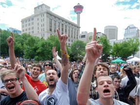 Excited fans of The Bronx raise their index fingers to the sky to cheer on the band performing on the main stage during the outdoor concerts as a part of Sled Island at Olympic Plaza in Calgary on July 3, 2010.