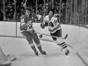 FILE - In this Dec. 18, 1977, file photo, Atlanta Flames' Tom Lysiak, left, and Chicago Blackhawks' Dale Tallon chase after the puck during the first period of an NHL hockey game in Chicago. Lysiak, a three-time NHL All-Star who played 13 NHL seasons with the Flames and Blackhawks, has died of leukemia at the age of 63. His daughter, Jessie Lysiak Braun, confirmed on Twitter that he died Monday, May 30, 2016.
