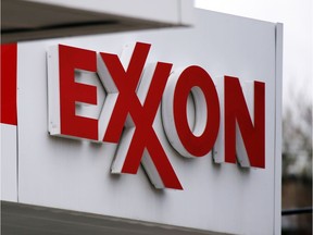 FILE - This April 29, 2014, file photo, shows an Exxon sign at a Exxon gas station in Carnegie, Pa. Exxon Mobil Corp. reports quarterly financial results on Tuesday, Feb. 2, 2016.