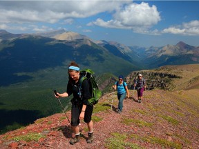 Hikers on Akimina Ridge with Waterton Lake National Park in the background.