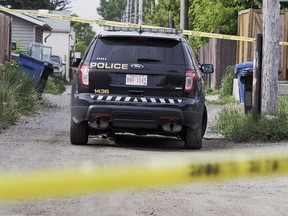 A police vehicle sits behind a Forest Lawn home as police investigate a death in the southeast Calgary community.