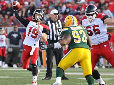 Calgary Stampeders quarterback Bo Levi Mitchell fires a pass as he is backed up by Stamps Dan Federkeil and threatened by Edmonton Eskimos Don Oramasionwu during CFL action at McMahon Stadium in Calgary, Alta.. on Saturday June 11, 2016. Mike Drew/Postmedia