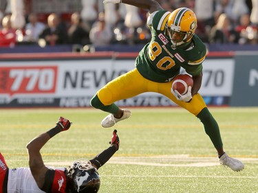 Edmonton Eskimos Bryant Mitchell evades a tackle by Calgary Stampeders Fred Bennett during CFL action at McMahon Stadium in Calgary, Alta.. on Saturday June 11, 2016. Mike Drew/Postmedia