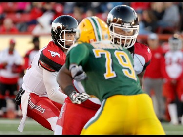 Calgary Stampeders quarterback Andrew Buckley keeps his eye on Edmonton Eskimos Kaelin Burnett as he takes the snap during CFL action at McMahon Stadium in Calgary, Alta.. on Saturday June 11, 2016. Mike Drew/Postmedia