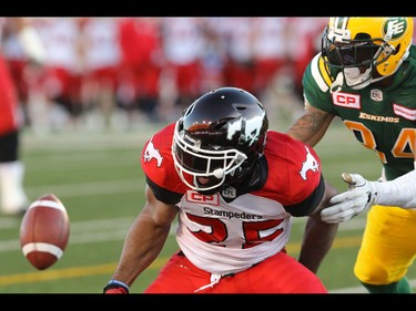 Calgary Stampeders Lache Seastrunk has the ball knocked away by Edmonton Eskimos Andrew Johnson during CFL action at McMahon Stadium in Calgary, Alta.. on Saturday June 11, 2016. The Stampeders lost the pore-season game to the Eskimos 23-13. Mike Drew/Postmedia