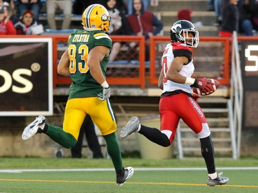 Calgary Stampeders Ciante Evans looks back at Edmonton Eskimos Brandon Zylstra as he runs a fumble in for a touchdown during CFL action at McMahon Stadium in Calgary, Alta.. on Saturday June 11, 2016. The Stampeders lost the pore-season game to the Eskimos 23-13. Mike Drew/Postmedia