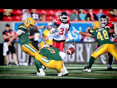 Edmonton Eskimos  Sean Whyte  kicks a field goal against Calgary Stampeders, as quarterback Jordan Lynch holds during CFL football in Calgary, Alta. on Saturday June 11, 2016. Al Charest/Calgary Sun/Postmedia Network