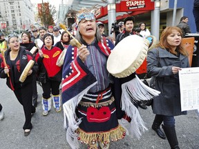 Chief Dolly Abraham, right, from Tatla Lake First Nations, holds a declaration as supporters march to the offices of Enbridge in Vancouver on Dec. 2, 2012.