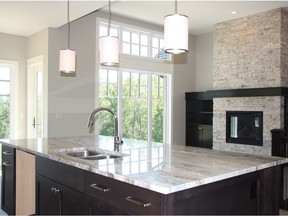 Kitchen and great room in the show home by Merchant Homes at the Slopes of Sylvan Lake.