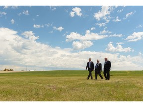 Trent Edwards, COO of Brookfield Residential, Coun. Jim Stevenson, and Alan Norris, president and CEO of Brookfield Residential, walk across the sites of future homes in the new community of Livingston in north central Calgary.
