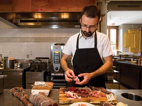 Chef Michele Pizzulo prepares a charcuterie platter full of made-in-house savoury treats at Teatro Restaurant.