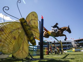 Leslie Howard of the USA, riding Up & Blue Chapelle, competes during the National show jumping event at Spruce Meadows in Calgary, Alta., Sunday, June 12, 2016.THE CANADIAN PRESS/Jeff McIntosh ORG XMIT: JMC108