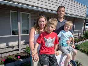 Allyson Palaschuk stands with her husband Anthony and sons Jack (L), 7, and William, 4, outside of her charity Made by Momma in Calgary on Tuesday, June 7, 2016. The child-nourishment group wanted to throw a block party for Neighbour Day, expecting the city's $25 fee to be waived as it normally is for Neighbour Day, but instead the permit cost $750 since it was considered an 'event' and didn't meet the criteria for a Neighbour Day party.