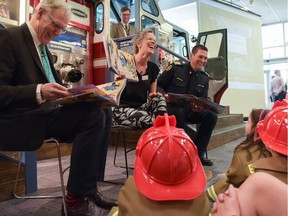 Bill Ptacek, CEO of Central Library, Tera Johnson, an author and employee of the library, and Joe Zatylny read stories about fire safety to students of W. H. Cushing Working School at the Central Library . A retired fire truck from the Calgary Fire Department became a permanent play structure inside the Central Library in Calgary on Friday, June 17, 2016.
