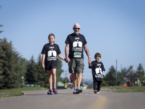 Fred Potter walks with his grandkids Jadyn Francoeur, 9, and Quinn Francoeur, 3, during the MEC Calgary Race 4 at Edworthy Park in Calgary, Alta., on Saturday, June 11, 2016. Potter walked for almost 10 minutes in the race to raise awareness of his condition, idiopathic pulmonary fibrosis (IPF), and called it the Six-Minute Marathon, named for a test used to monitor patients with the disease.