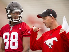 Head coach Dave Dickenson speaks with Kamar Jorden during the Calgary Stampeders training camp at McMahon Stadium in Calgary, Alta., on Wednesday, June 1, 2016. The regular season begins on June 25, when the Stamps head to B.C. Lyle Aspinall/Postmedia Network