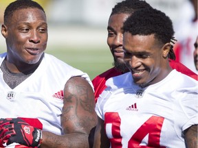 Micah Johnson chats with teammate Frank Beltre during the Calgary Stampeders training camp at McMahon Stadium in Calgary, Alta., on Tuesday, May 31, 2016. The regular season begins on June 25, when the Stamps head to B.C. Lyle Aspinall/Postmedia Network