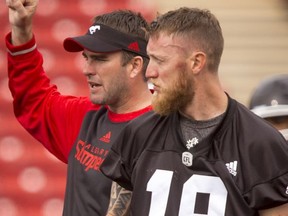 Quarterback coach Ryan Dinwiddie works next to quarterback Bo Levi Mitchell during the Calgary Stampeders training camp at McMahon Stadium in Calgary, Alta., on Wednesday, June 1, 2016. The regular season begins on June 25, when the Stamps head to B.C. Lyle Aspinall/Postmedia Network