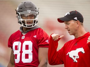 Head coach Dave Dickenson speaks with Kamar Jorden during the Calgary Stampeders training camp at McMahon Stadium in Calgary, Alta., on Wednesday, June 1, 2016. The regular season begins on June 25, when the Stamps head to B.C. Lyle Aspinall/Postmedia Network
