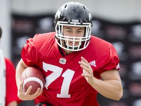 Pierre-Luc Caron carries a ball on Day 1 of the Calgary Stampeders rookie camp at McMahon Stadium in Calgary on May 26, 2016.