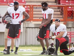 Newcomer Demetrius Wright (17) chats with Joshua Bell during the Calgary Stampeders training camp at McMahon Stadium in Calgary, Alta., on Wednesday, June 8, 2016. The regular season begins on June 25, when the Stamps head to B.C. Lyle Aspinall/Postmedia Network