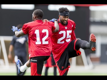 Roy Finch (L) and Lache Seastrunk warm up on Day 1 of the Calgary Stampeders rookie camp at McMahon Stadium in Calgary, Alta., on Thursday, May 26, 2016. Regular training camp was set to begin on May 29.  Lyle Aspinall/Postmedia Network