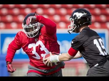 Jerome Messam and quarterback Bo Levi Mitchell run through a drill during the Calgary Stampeders training camp in Calgary, Alta., on Monday, May 30, 2016. The regular season begins on June 25, when the Stamps head to B.C. Lyle Aspinall/Postmedia Network
