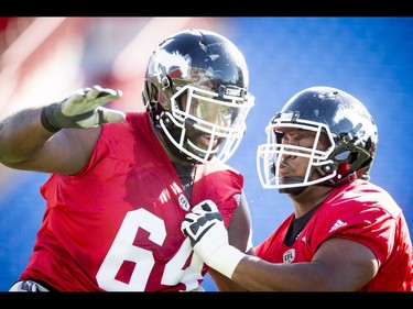 Derek Dennis (L) works against Ucambre Williams during the Calgary Stampeders training camp at McMahon Stadium in Calgary, Alta., on Tuesday, May 31, 2016. The regular season begins on June 25, when the Stamps head to B.C. Lyle Aspinall/Postmedia Network