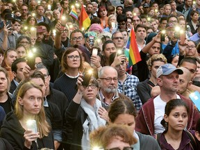 Supporters light candles and shine their mobile phone lights during the Los Angeles Rally and Vigil for Orlando at Los Angeles City Hall in Los Angeles, on Monday June 13, 2016.