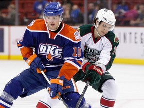 Teemu Hartikainen of the Oklahoma City Barons, left, tries to keep the puck away from Kris Foucault of the Houston Aeros in an American Hockey League game at the Cox Convention Center in Oklahoma City on Nov. 2, 2012.