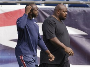 New England Patriots defensive tackle Vince Wilfork, right, and linebacker Ja'Gared Davis (53) walk onto the field for a walk-through at the NFL football team's facility Tuesday, Oct. 14, 2014 in Foxborough, Mass. The Patriots will play the New York Jets in Foxborough Thursday night.