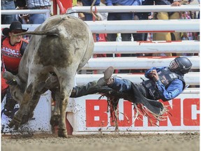 Tanner Byrne falls off Silence Reins at last year's Calgary Stampede. Byrne is not your typical bull rider, standing at six-foot-four.