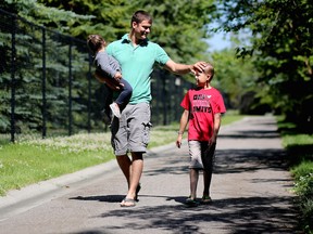 Brent Lewelling, with his daughter Adelina, 21 months, left, spends time with Erik Gracia, 9, in Calgary on Thursday, July 7, 2016. Lewelling was the bone marrow donor who helped save Erik's life.