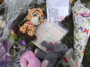 A memorial continues to grow outside the house at 1111 Panamount Boulevard NW Wednesday morning July 13, 2016. An Amber Alert was  issued for the safe return of five year old Taliyah Marsman after her mother was found dead Monday night in the basement suite of the home. (Ted Rhodes/Postmedia)