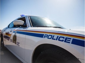 RCMP logo and police cars outside of Calgary on Friday, April 10, 2015.