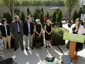 Christina Gray (right at podium/Alberta Labour Minister) announced changes to the province's minimum wage rates at the Muttart Conservatory in Edmonton on Thursday June 30, 2016, as Alberta moves forward towards a $15-per-hour minimum wage by 2018.